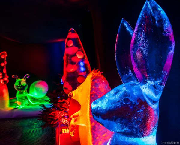 Bunt beleuchtete Eisskulpturen, die in Form von Pilzen, Tieren und Kindern