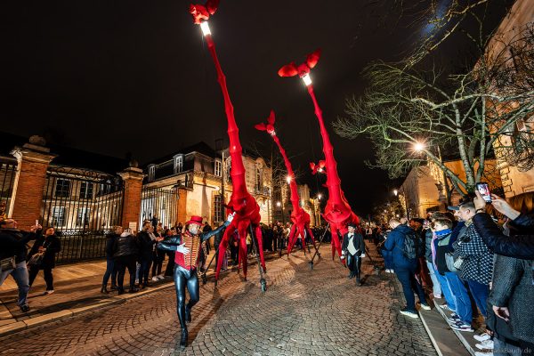 Riesige rote Giraffen von Compagnie Off ziehen durch die Avenue de Champagne bei Habits de Lumière